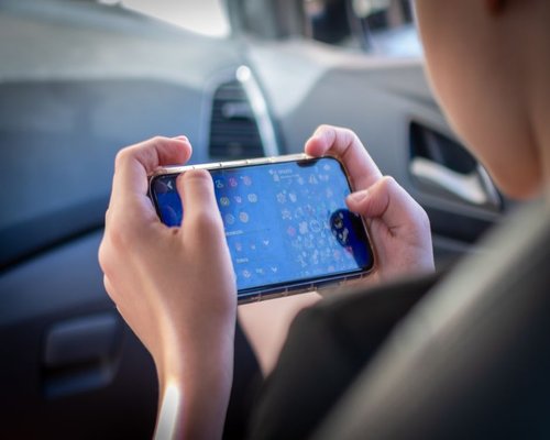 Smartphone showing a fictional mobile racing game